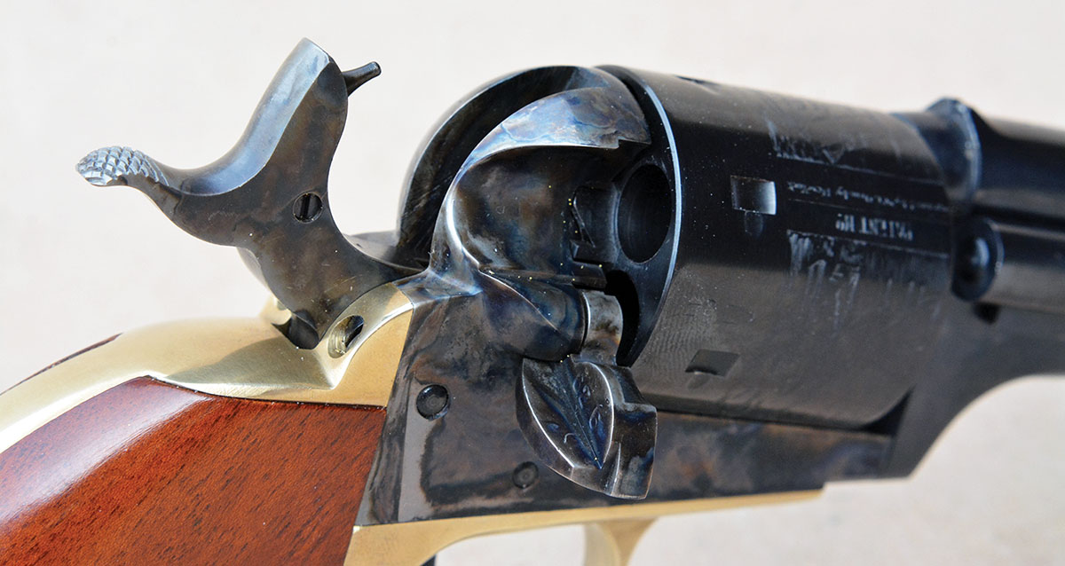 The Cimarron Model 1872 Open Top features a hammer mounted firing pin, a loading gate and functions similarly to the Colt SAA. Note the  Basic Safety Block screw on the right side of  the hammer.